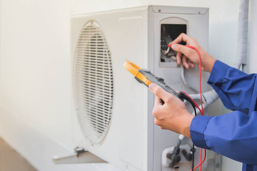 Air conditioning, HVAC service technician using gauges to checkrefrigerant and add refrigerant
