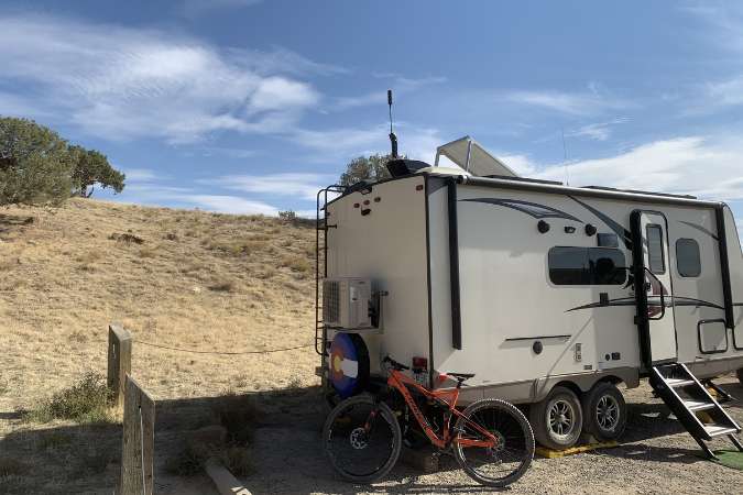 An RV with mini split stops with a bike