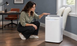 Woman checking portable air conditioner airflow